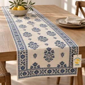 Blue floral block print cotton table runner on a wooden dining table with a removable Casa tag.
