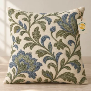 Cushion cover with blue and green crewel embroidery and a removable Casa paper tag.