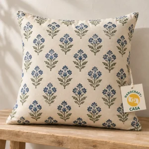 Cotton cushion cover with repeating blue and green hand-block print motifs and a removable Casa paper tag.