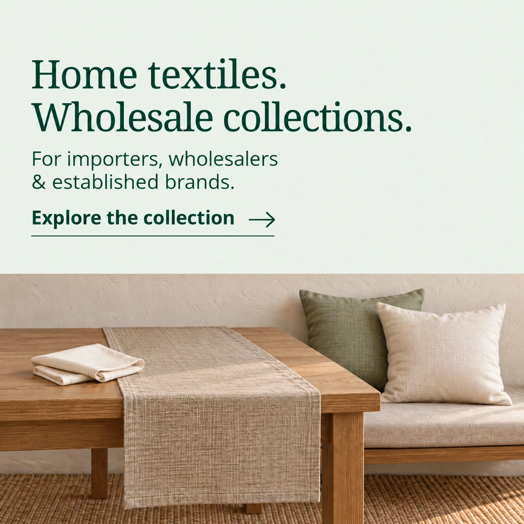 Home textiles. Wholesale collections. For importers, wholesalers & established brands. Explore the collection. Illustrative table runner, folded napkins and sage and ivory cushions.