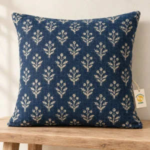 Indigo blue cushion cover with ivory botanical print and a removable Casa paper tag.