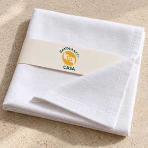 Folded white plain cotton dinner napkin with a removable Casa paper band.