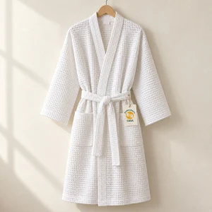 White waffle kimono bathrobe on a hanger with a removable Casa tag.