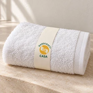 Folded white zero twist hand towel with a removable Casa paper band.